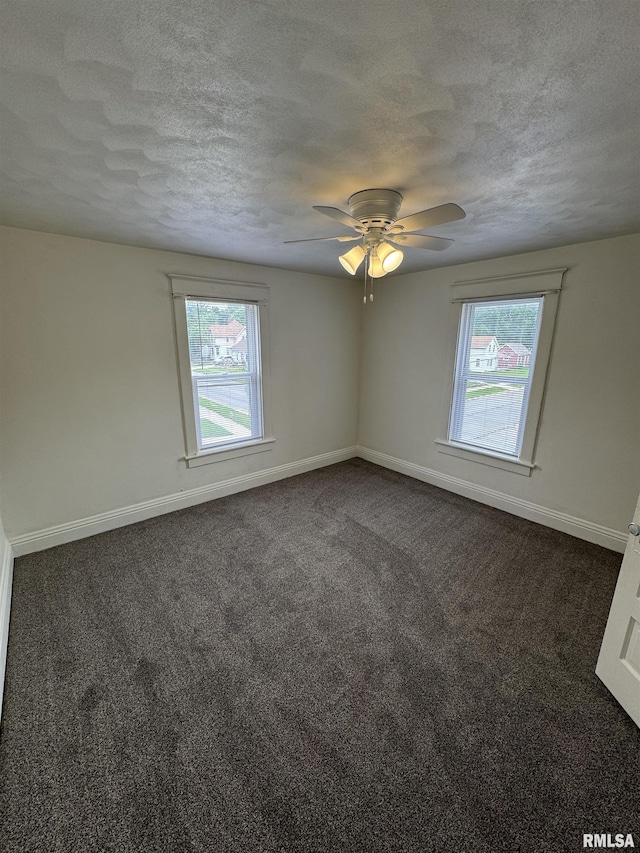 60 E Ash St, Canton, IL 61520 - unfurnished room featuring plenty of natural light, a textured ceiling, dark colored carpet, and a ceiling fan