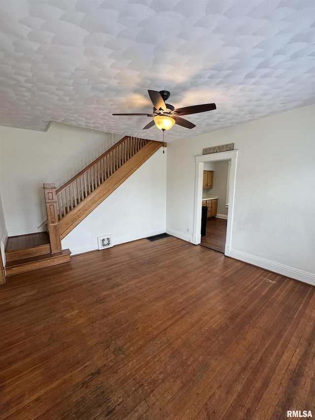 60 E Ash St, Canton, IL 61520 - unfurnished living room featuring ceiling fan, stairs, and dark wood-style floors