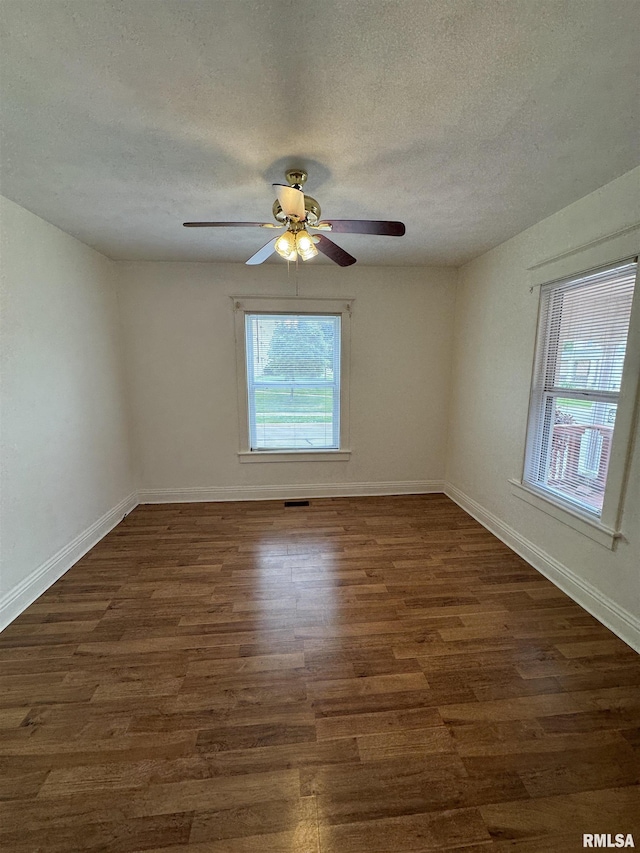 60 E Ash St, Canton, IL 61520 - spare room with plenty of natural light, dark wood finished floors, a textured ceiling, and ceiling fan