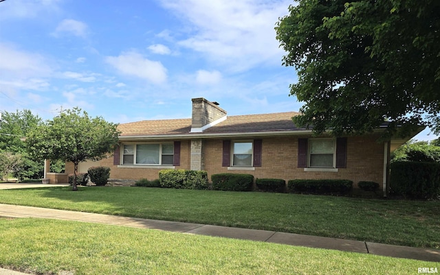 901 Coolidge Ave, Pekin, IL 61554 - view of front of home featuring a front yard, brick siding, a chimney, and a garage