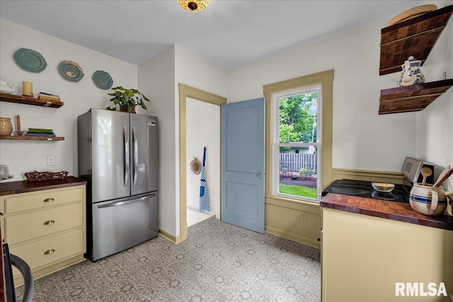 2623 W Ardmore Pl, West Peoria, IL 61604 - kitchen with freestanding refrigerator, open shelves, wooden counters, baseboards, and wainscoting