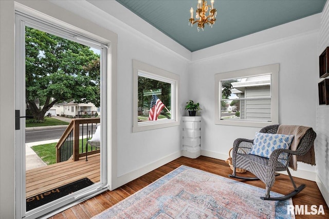 2623 W Ardmore Pl, West Peoria, IL 61604 - living area featuring a chandelier, baseboards, and wood finished floors