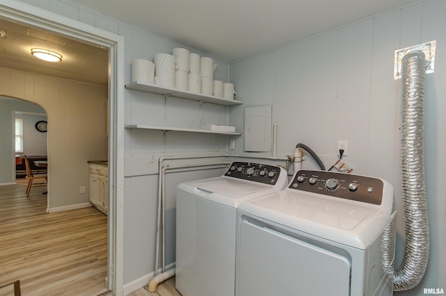 153 Hollywood Cir, Creve Coeur, IL 61610 - washroom with washing machine and dryer, arched walkways, light wood-style flooring, baseboards, and a decorative wall