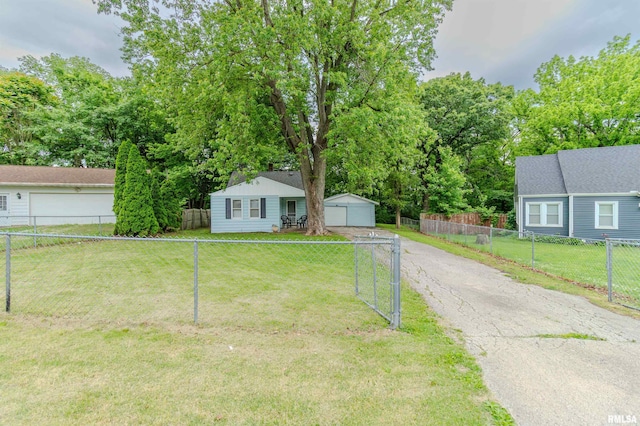153 Hollywood Cir, Creve Coeur, IL 61610 - view of front of house with a garage, an outdoor structure, and view of wooded area