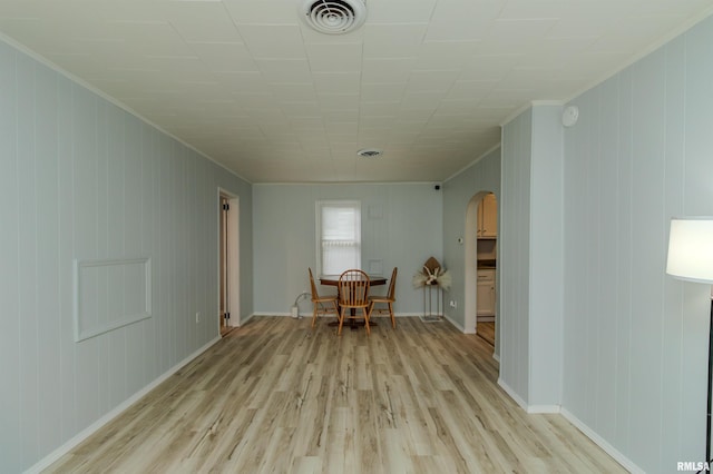 153 Hollywood Cir, Creve Coeur, IL 61610 - empty room featuring arched walkways, light wood-type flooring, crown molding, and baseboards