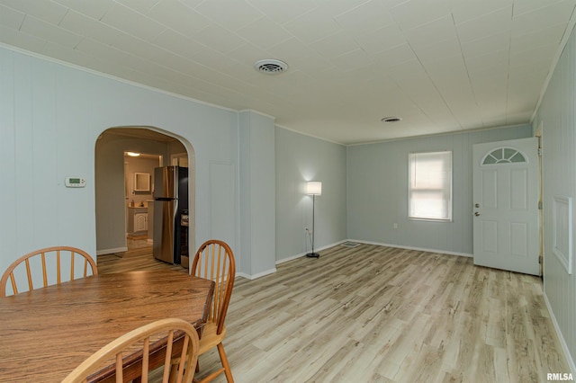 153 Hollywood Cir, Creve Coeur, IL 61610 - unfurnished dining area with ornamental molding, arched walkways, and light wood-style floors