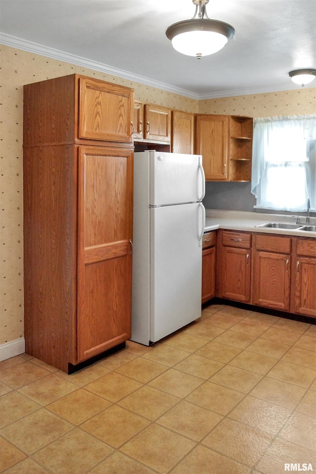 419 S Franklin St, Toulon, IL 61483 - kitchen with freestanding refrigerator, a sink, crown molding, open shelves, and wallpapered walls