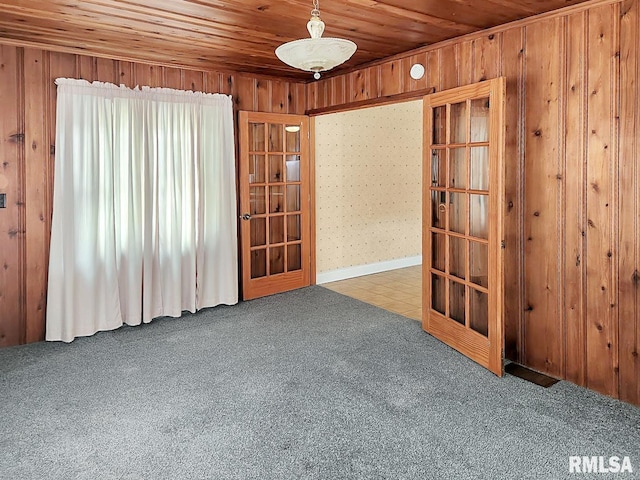 419 S Franklin St, Toulon, IL 61483 - spare room featuring carpet floors, wooden walls, and wood ceiling
