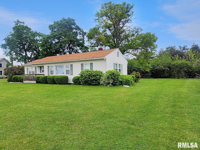 419 S Franklin St, Toulon, IL 61483 - view of front of home featuring a front lawn and a chimney
