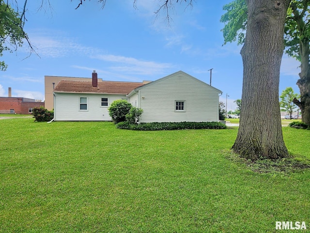 419 S Franklin St, Toulon, IL 61483 - rear view of house featuring a lawn and a chimney