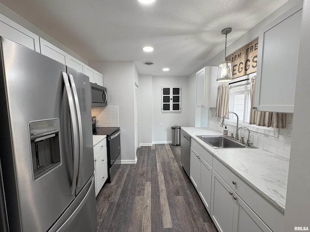 606 Lasalle Blvd, Marquette Heights, IL 61554 - kitchen with stainless steel appliances, a sink, tasteful backsplash, baseboards, and dark wood-style floors