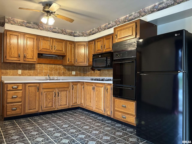 6 Bay Shore Dr, Lacon, IL 61540 - kitchen with black appliances, a warming drawer, a ceiling fan, a sink, and brown cabinetry