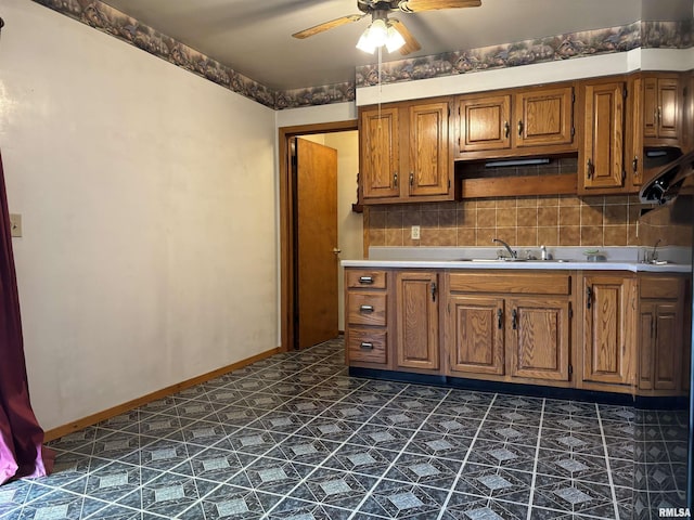 6 Bay Shore Dr, Lacon, IL 61540 - kitchen with brown cabinets, ceiling fan, a sink, and baseboards