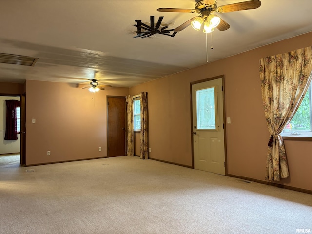 6 Bay Shore Dr, Lacon, IL 61540 - unfurnished living room featuring a ceiling fan, plenty of natural light, baseboards, and light colored carpet