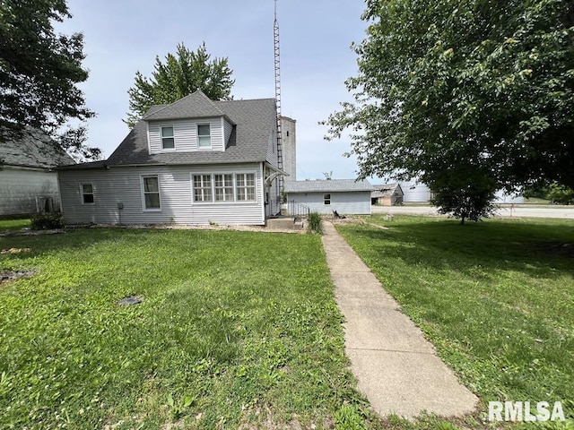 102 W 1st St, Table Grove, IL 61482 - view of front facade with a front lawn and a shingled roof