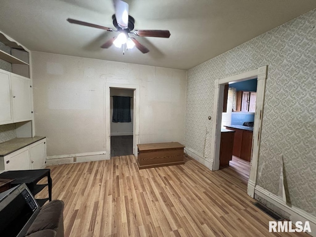 102 W 1st St, Table Grove, IL 61482 - unfurnished office featuring ceiling fan, light wood-style floors, and baseboards
