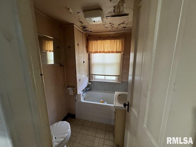 102 W 1st St, Table Grove, IL 61482 - full bath with toilet, a garden tub, and brick patterned flooring