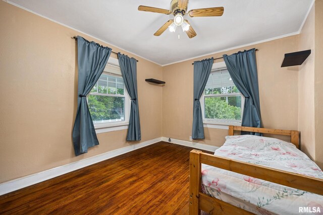 1614 W Columbia Ter, Peoria, IL 61606 - bedroom with multiple windows, wood finished floors, baseboards, crown molding, and a ceiling fan
