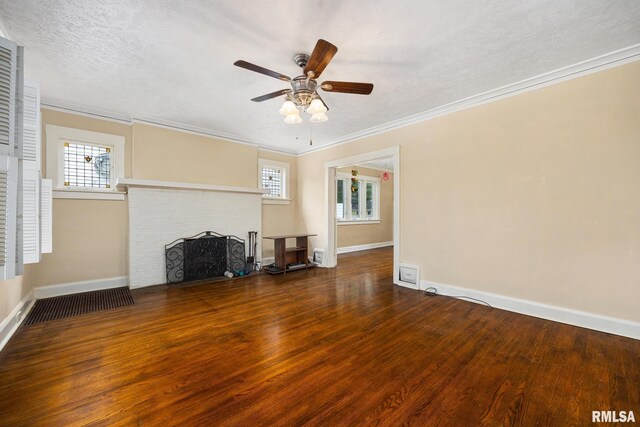 1614 W Columbia Ter, Peoria, IL 61606 - unfurnished living room featuring wood finished floors, a ceiling fan, baseboards, a brick fireplace, and ornamental molding