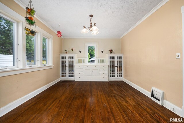 1614 W Columbia Ter, Peoria, IL 61606 - unfurnished dining area with a chandelier, wood finished floors, baseboards, a textured ceiling, and crown molding