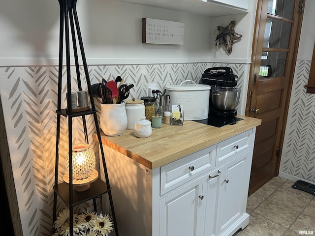 313 N Edwards St, Macomb, IL 61455 - kitchen featuring wooden counters, white cabinets, and wainscoting