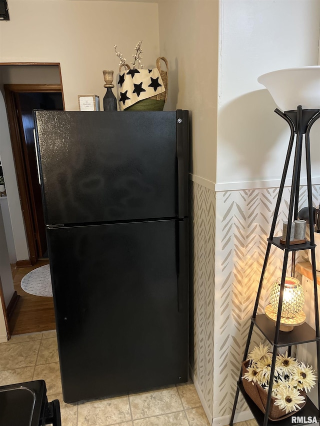 313 N Edwards St, Macomb, IL 61455 - kitchen with freestanding refrigerator and a wainscoted wall