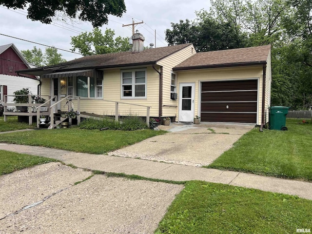 313 N Edwards St, Macomb, IL 61455 - view of front facade with driveway, an attached garage, a chimney, a front yard, and roof with shingles