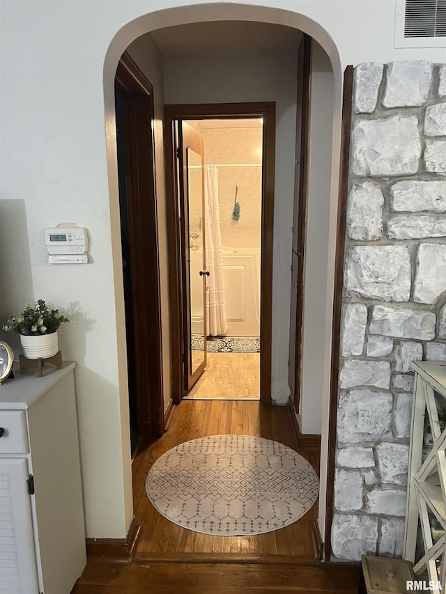 313 N Edwards St, Macomb, IL 61455 - hall with light wood finished floors, arched walkways, and baseboards