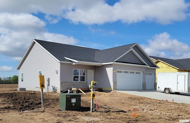 1312 Hillcrest Dr, Chillicothe, IL 61548 - view of front of house featuring a garage, driveway, stone siding, and roof with shingles