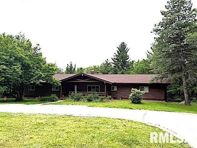 1 Marty Ln, Macomb, IL 61455 - log-style house with a front yard and concrete driveway