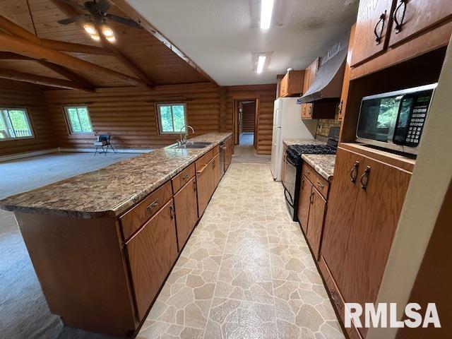 1 Marty Ln, Macomb, IL 61455 - unfurnished living room featuring a ceiling fan, vaulted ceiling, rustic walls, light colored carpet, and recessed lighting
