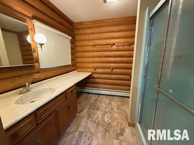 1 Marty Ln, Macomb, IL 61455 - full bath featuring vanity, log walls, a shower with door, and a baseboard heating unit