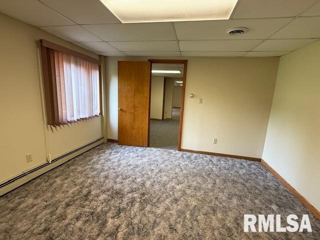 1 Marty Ln, Macomb, IL 61455 - carpeted spare room featuring a baseboard heating unit, a paneled ceiling, and baseboards