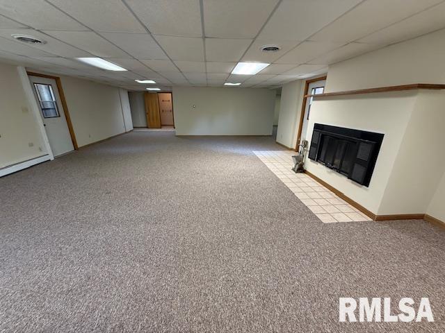 1 Marty Ln, Macomb, IL 61455 - spare room with carpet flooring, baseboard heating, a paneled ceiling, and baseboards