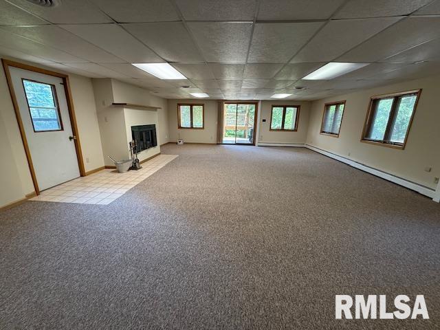 1 Marty Ln, Macomb, IL 61455 - unfurnished living room with a drop ceiling, light carpet, baseboards, and a fireplace with flush hearth