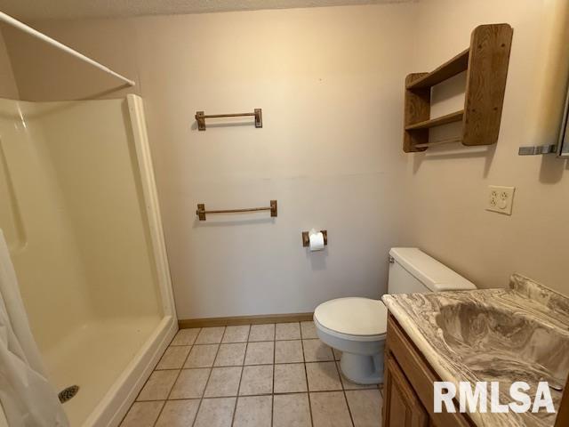 1 Marty Ln, Macomb, IL 61455 - unfurnished living room with carpet flooring, a drop ceiling, baseboards, a fireplace with flush hearth, and plenty of natural light