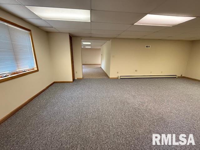1 Marty Ln, Macomb, IL 61455 - unfurnished living room featuring a drop ceiling, carpet floors, a fireplace with flush hearth, baseboards, and baseboard heating