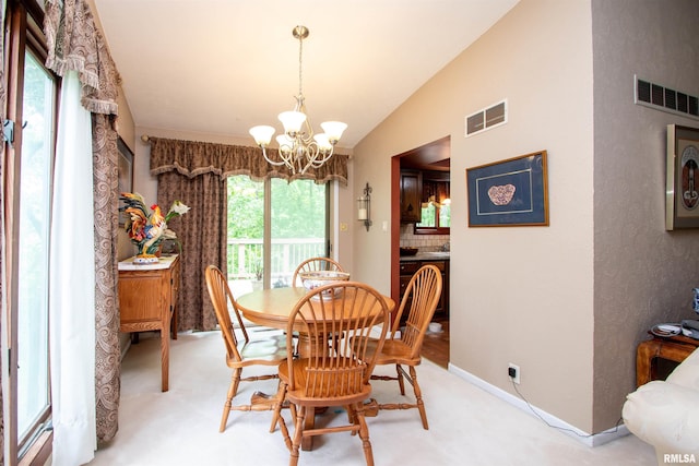 32 Black Partridge Run, Hopewell, IL 61565 - dining space featuring a chandelier, light colored carpet, and lofted ceiling