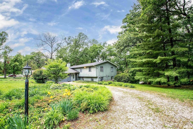 32 Black Partridge Run, Hopewell, IL 61565 - view of front facade featuring a chimney and view of wooded area