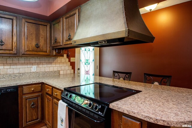 32 Black Partridge Run, Hopewell, IL 61565 - kitchen featuring wall chimney range hood, black appliances, light countertops, tasteful backsplash, and a peninsula