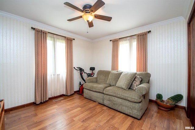 32 Black Partridge Run, Hopewell, IL 61565 - living area featuring light wood finished floors, healthy amount of natural light, a ceiling fan, crown molding, and wallpapered walls