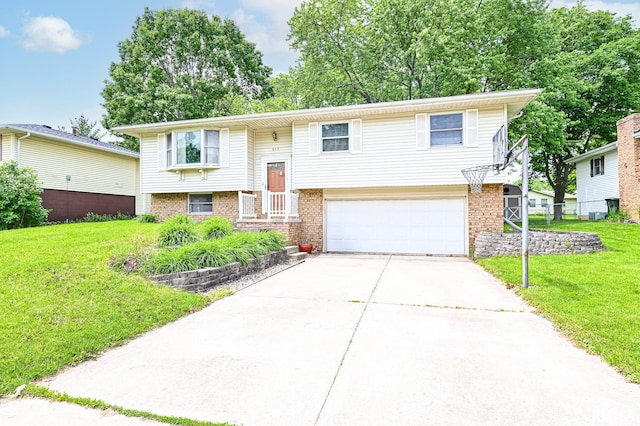 311 Juniper Ln, East Peoria, IL 61611 - split foyer home with an attached garage, driveway, a front yard, and brick siding