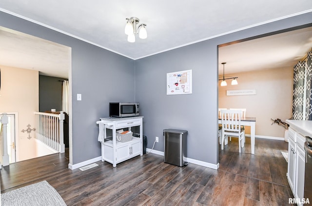 311 Juniper Ln, East Peoria, IL 61611 - kitchen with stainless steel appliances, dark wood finished floors, baseboards, ornamental molding, and light countertops