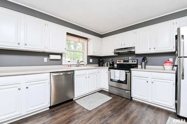 311 Juniper Ln, East Peoria, IL 61611 - kitchen featuring stainless steel appliances, under cabinet range hood, a sink, dark wood finished floors, and white cabinets