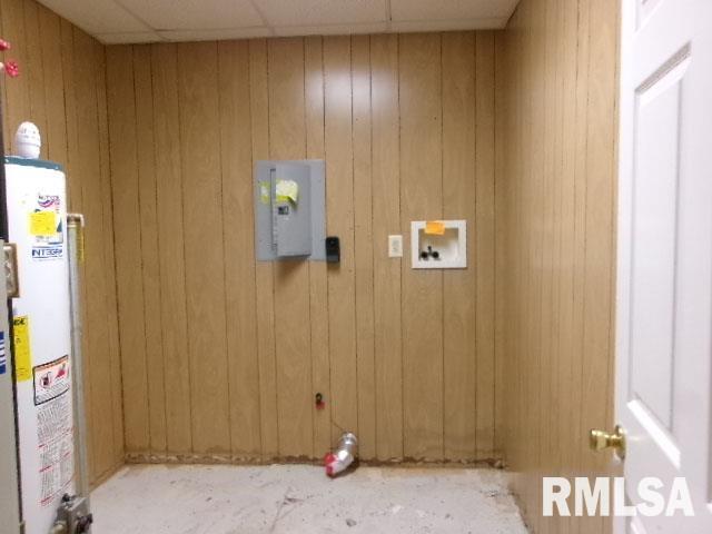 837 E Chestnut St, Canton, IL 61520 - washroom featuring water heater, washer hookup, and wood walls
