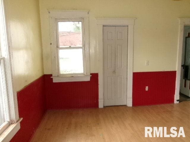 896 E Chestnut St, Canton, IL 61520 - empty room with a wainscoted wall and wood finished floors