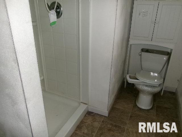 896 E Chestnut St, Canton, IL 61520 - full bath with a shower stall, toilet, and tile patterned floors