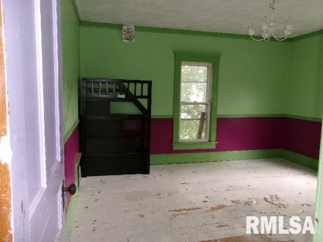 896 E Chestnut St, Canton, IL 61520 - unfurnished room featuring a chandelier