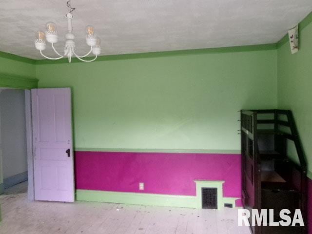 896 E Chestnut St, Canton, IL 61520 - unfurnished room with a chandelier and baseboards