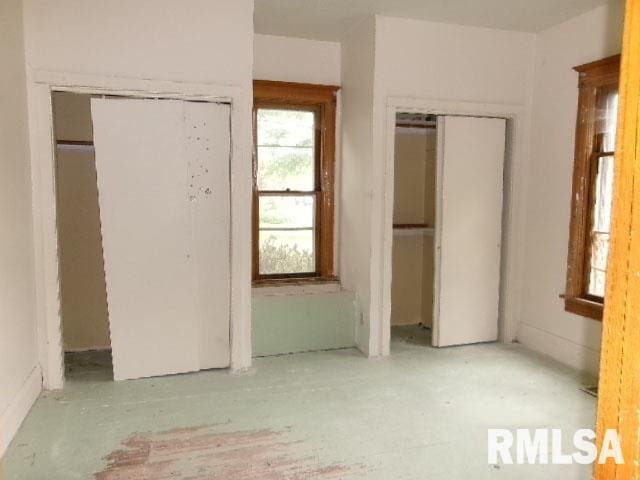 896 E Chestnut St, Canton, IL 61520 - unfurnished bedroom featuring multiple closets